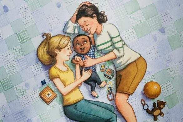 two mothers snuggling their baby