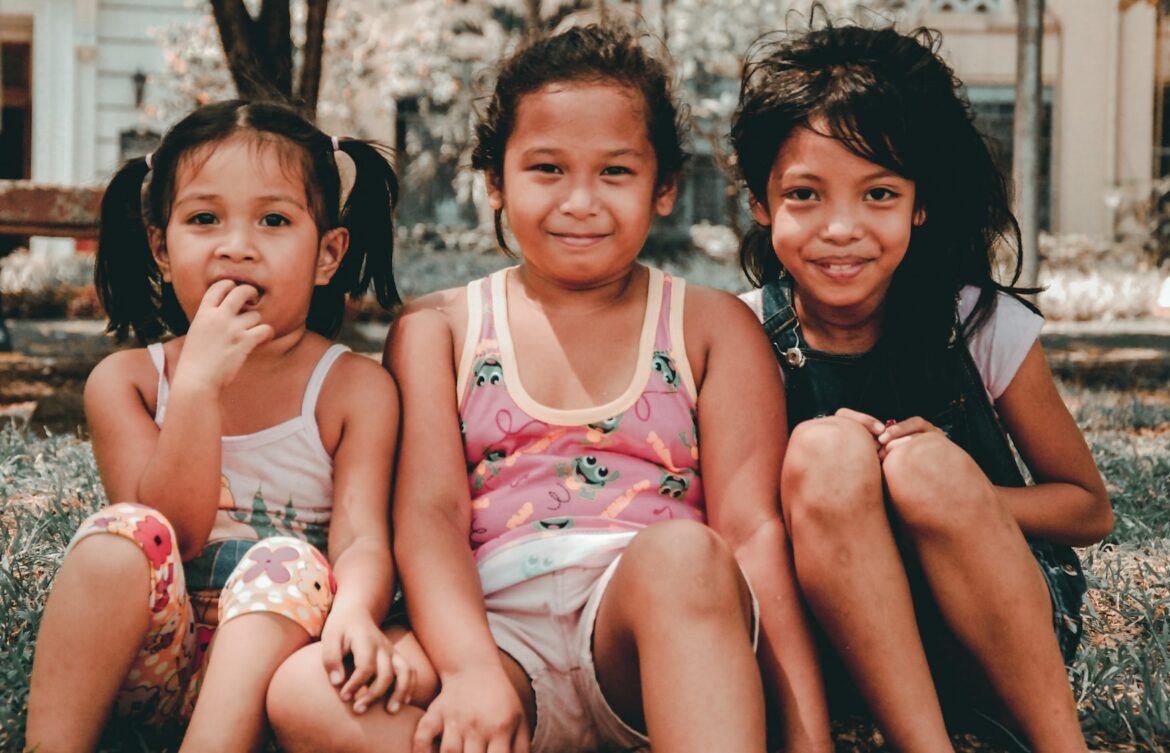 three kid friends smiling at camera
