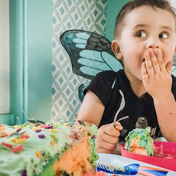 3-year-old boy eats birthday cake